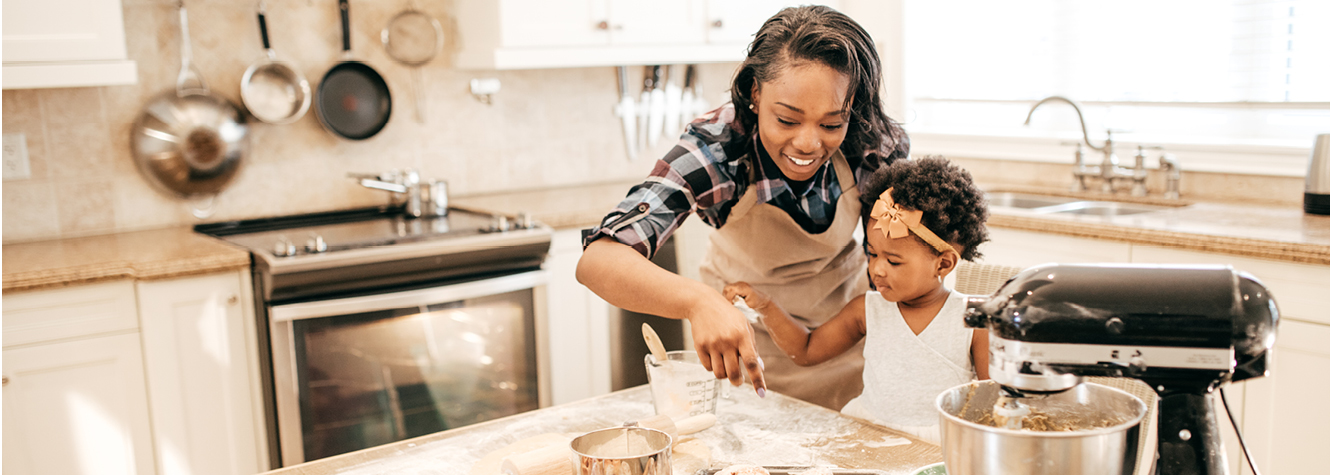 Mother and daughter baking in a newly remodeled kitchen.