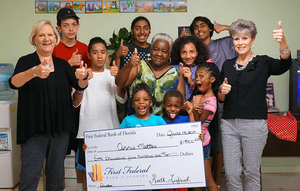 Kids from the Annie Mattox Park give the "thumbs-up" as they get their check from First Federal's Community Rewards Program.
