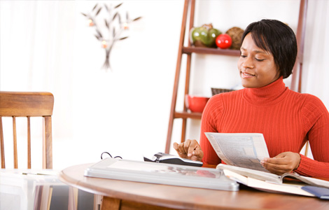 Woman at table crunching the numbers