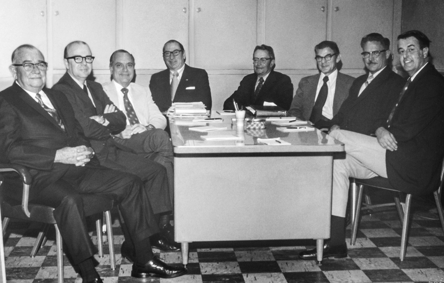 First Federal Bank's original Board of Directors sit around a desk.