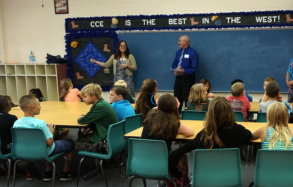 First Federal employees make a presentation to a classroom of students.