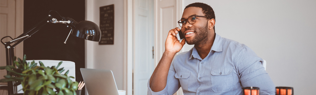 Man on the phone, in his office.