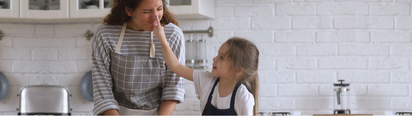 A mother and daughter working together in the kitchen