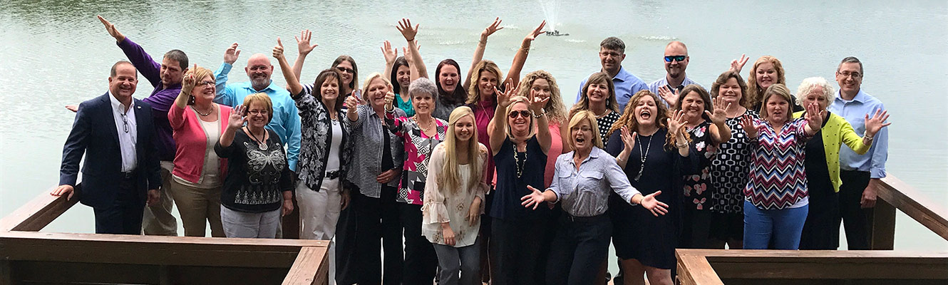 Part of our Management Team celebrates during a training retreat.