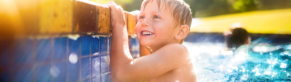 Young boy swimming in pool