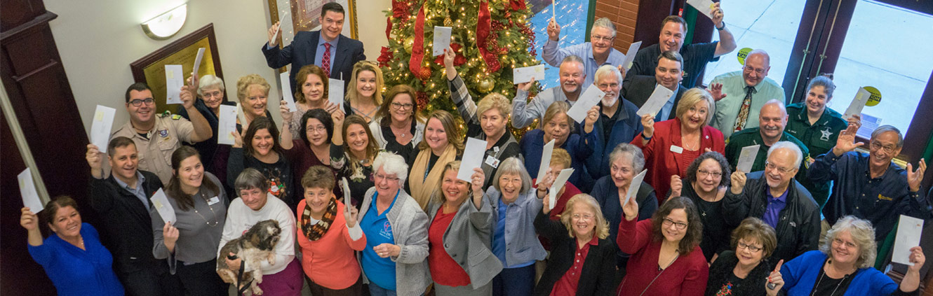 Representatives from local organizations hold up the checks they received through First Federal Bank's First Federal Way program.