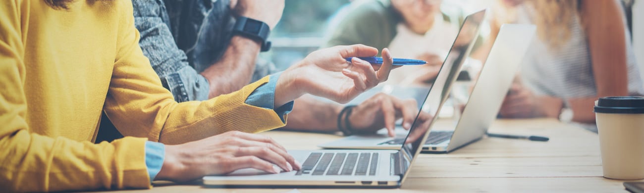 co workers looking at laptop
