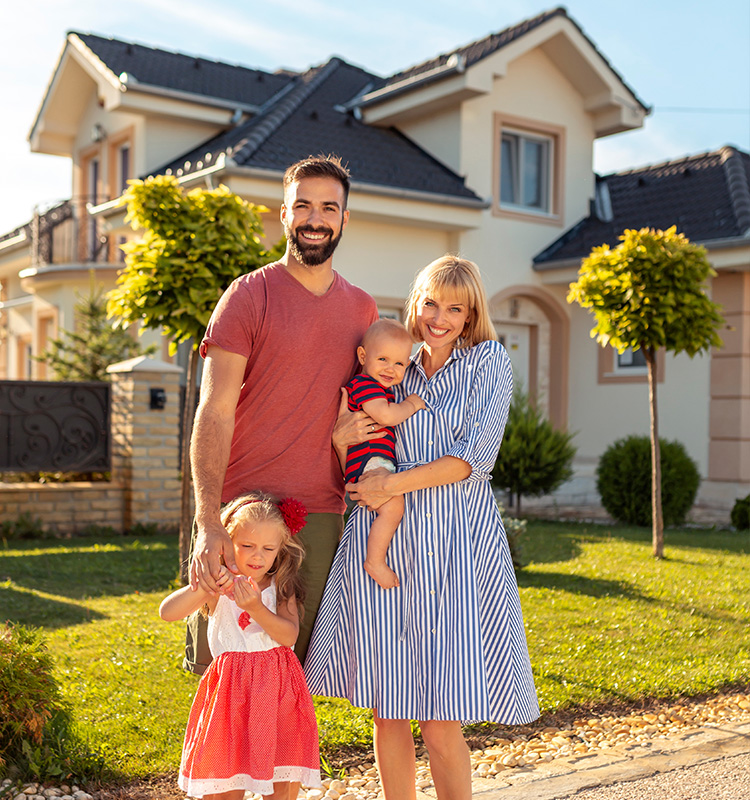 family standing in front of house