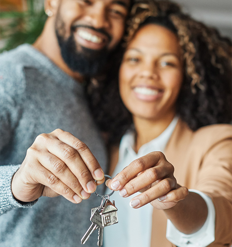 couple holding keys to new home