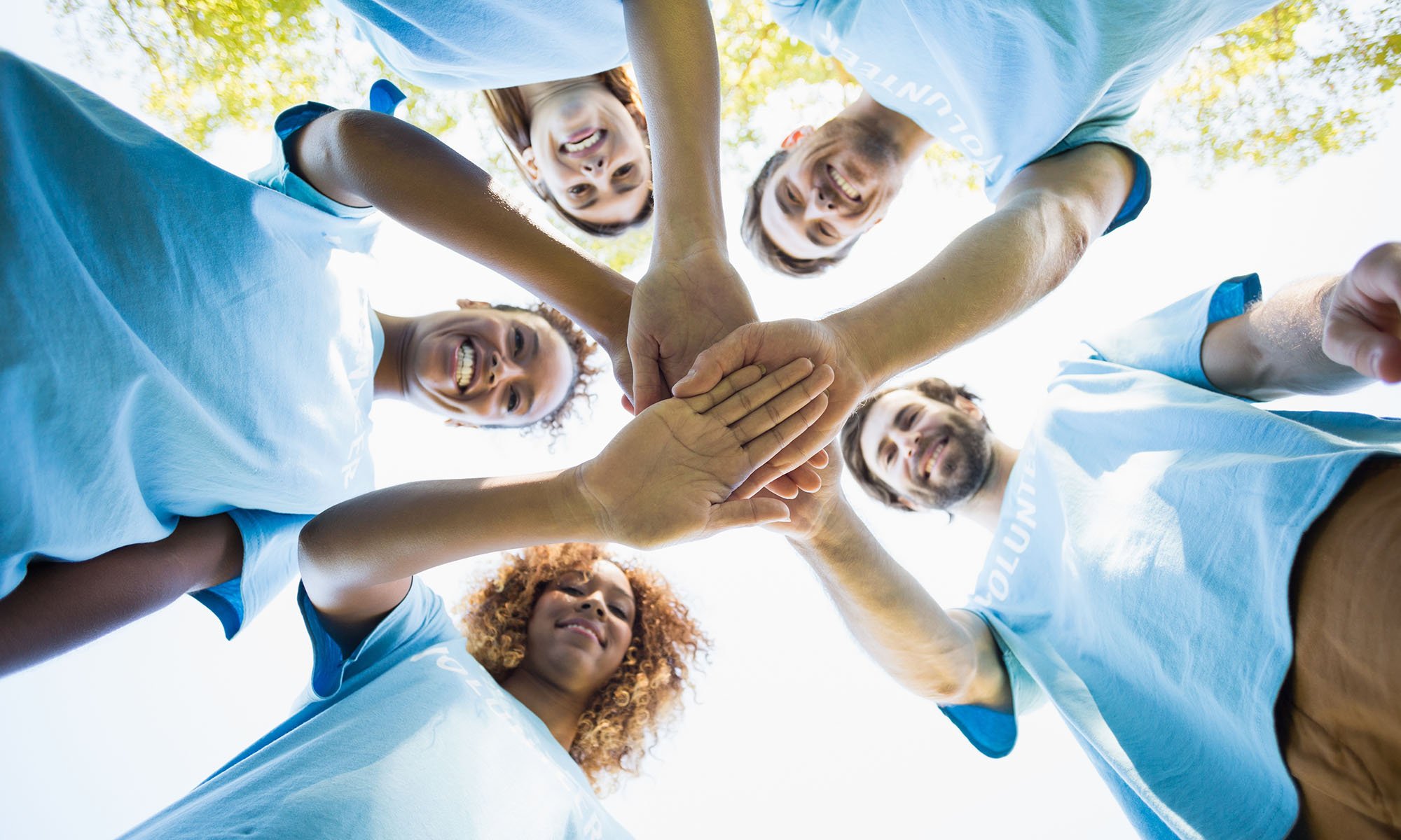volunteers putting hands together