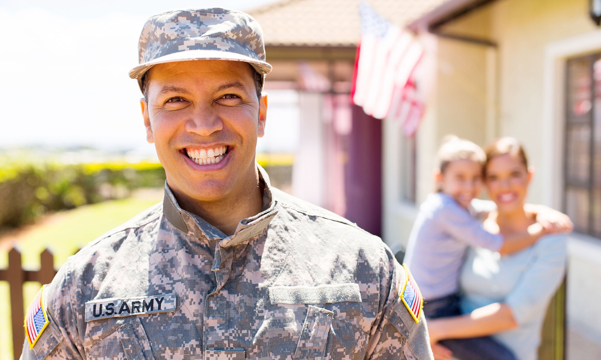 veteran dad in front of new home