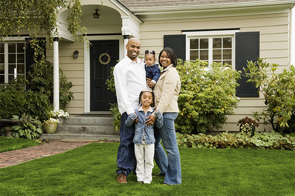 family in front of house